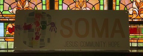 A sign that says SOMA, Jesus, Community, Hope