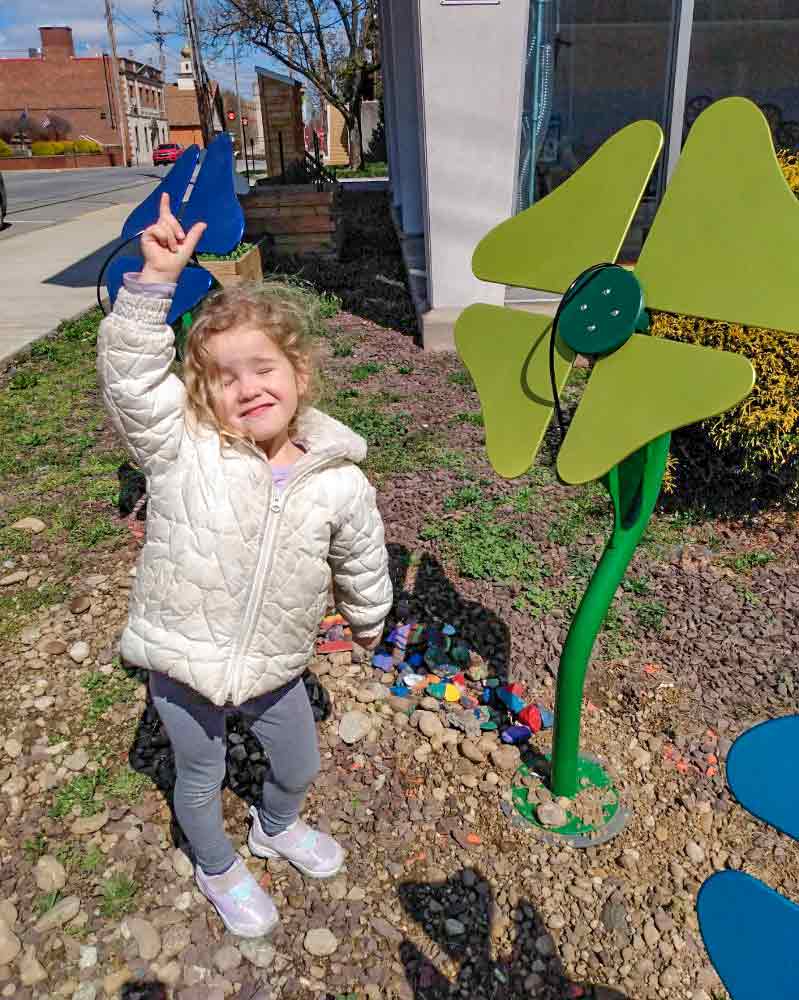 Girl at musical flowers