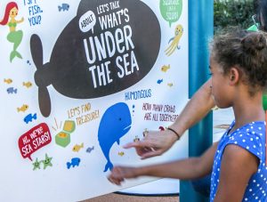 Girl at whats under the sea board